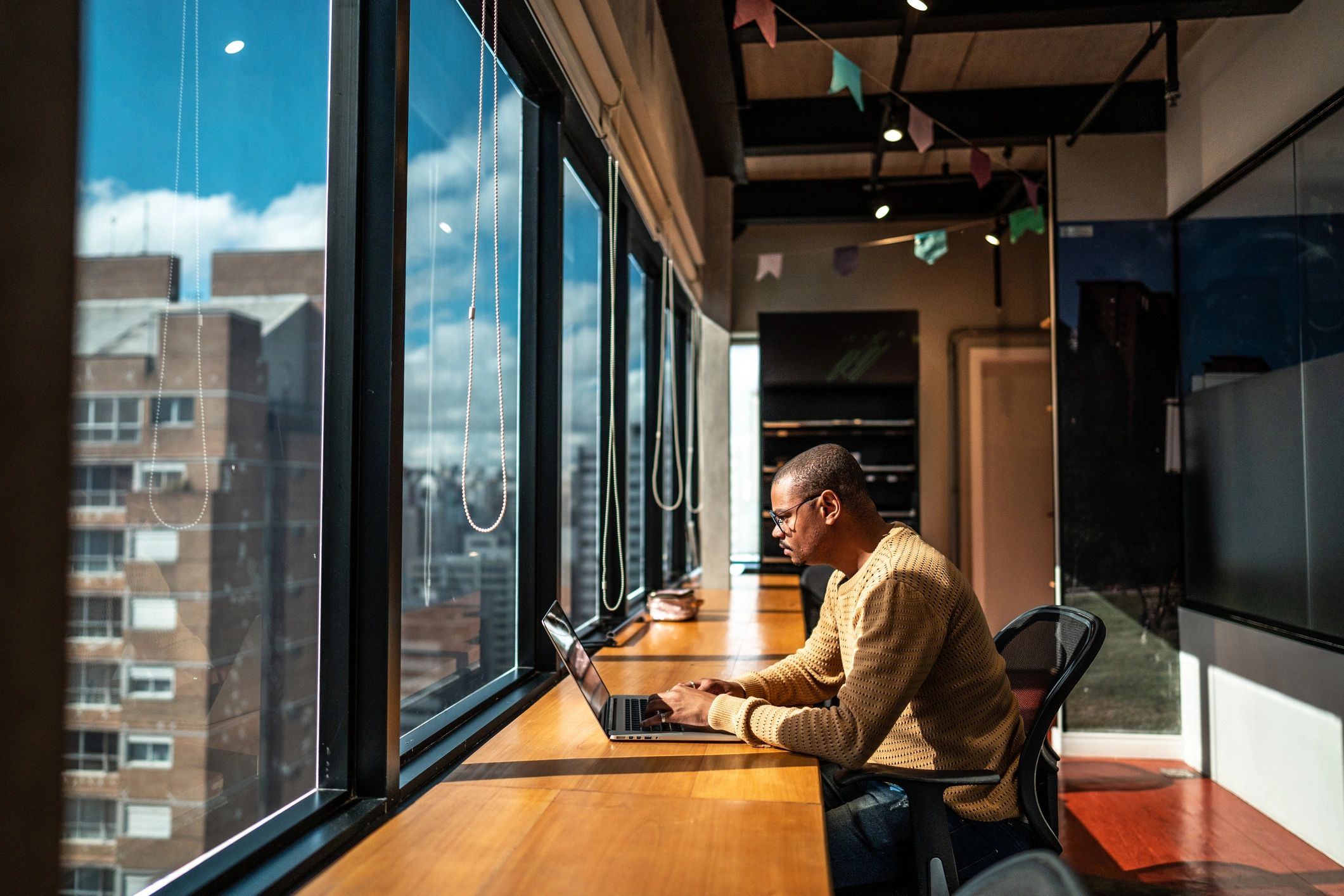 Software developer working on a laptop in a modern office