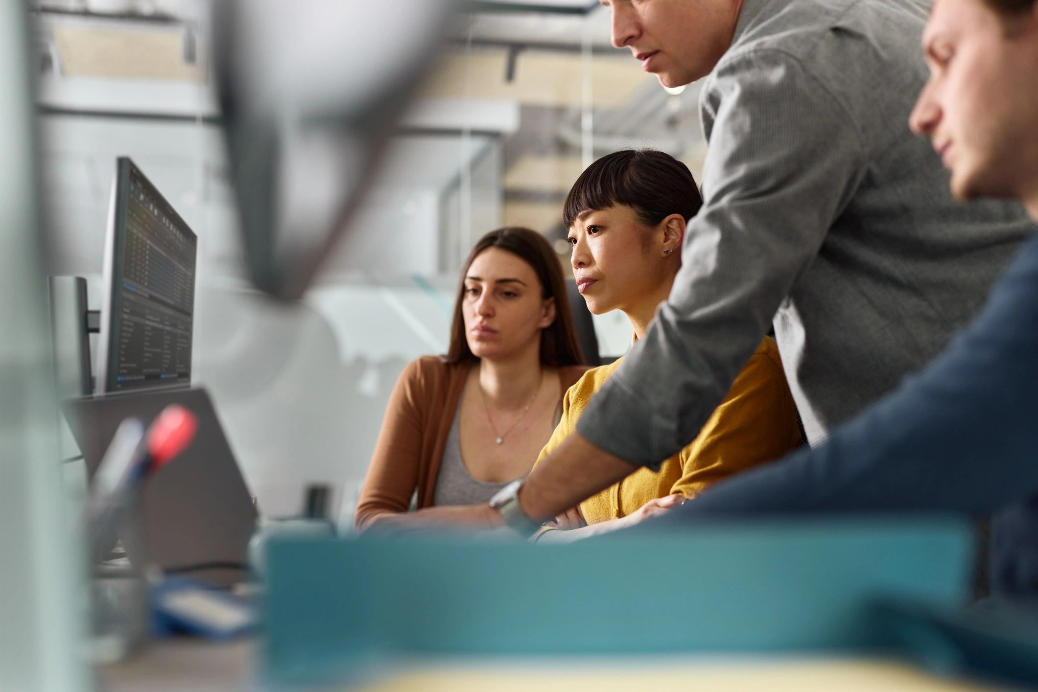 IT support team collaborating on laptops and desktops