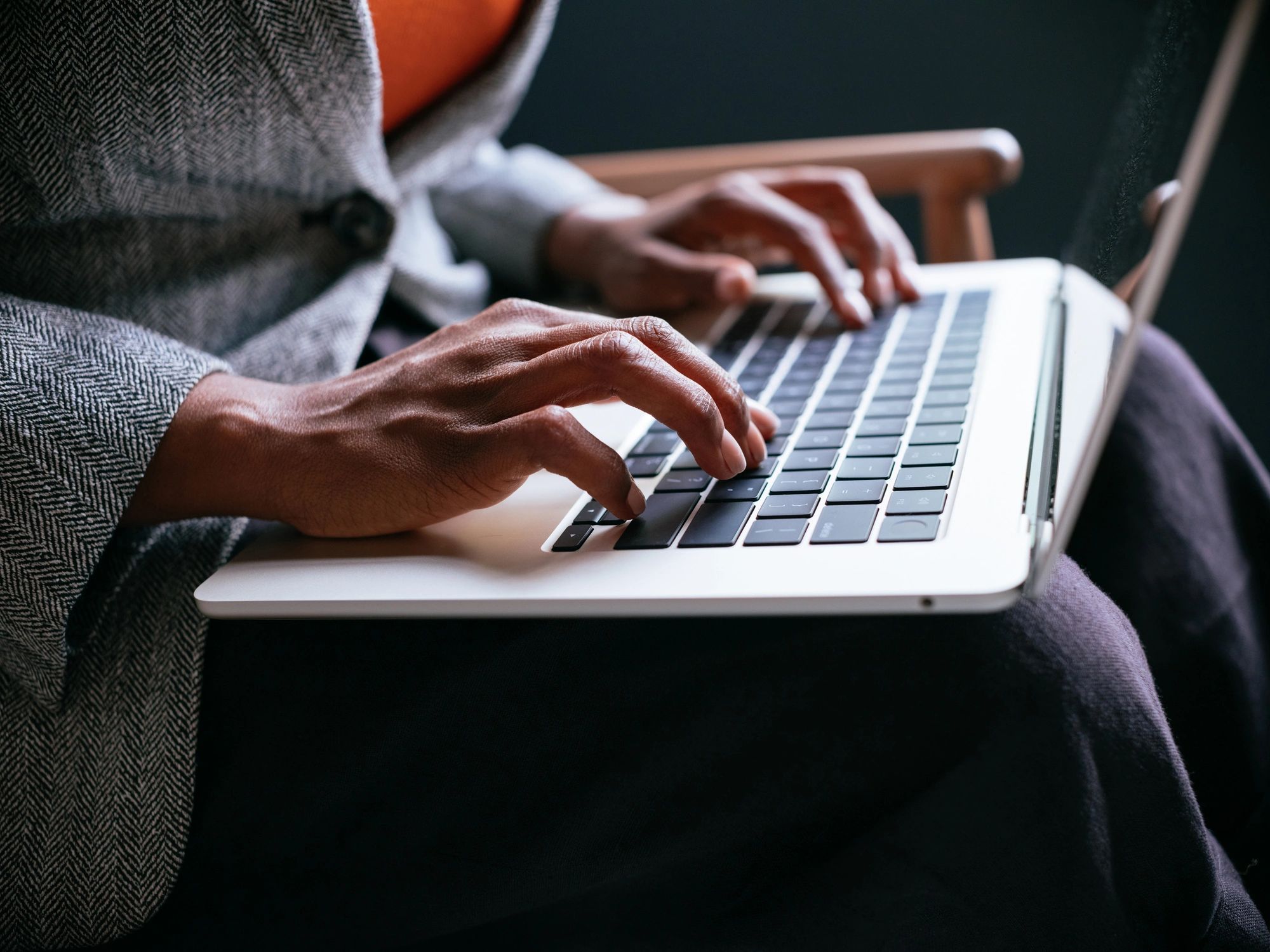 Professional typing on a laptop representing cybersecurity work